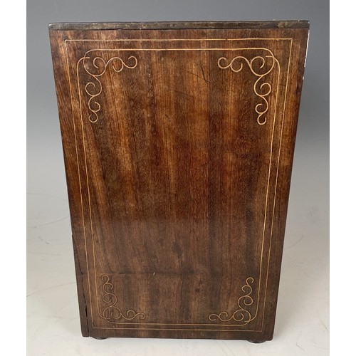 1863 - A 19th century Italian table top collectors cabinet, inlaid with figures, the hinged door to reveal ... 