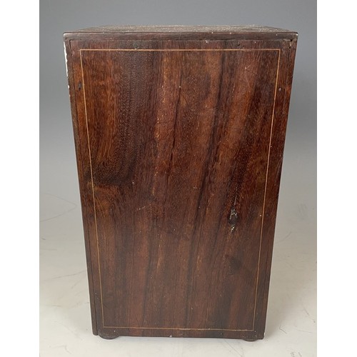 1863 - A 19th century Italian table top collectors cabinet, inlaid with figures, the hinged door to reveal ... 