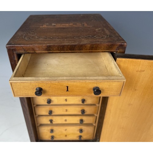 1863 - A 19th century Italian table top collectors cabinet, inlaid with figures, the hinged door to reveal ... 