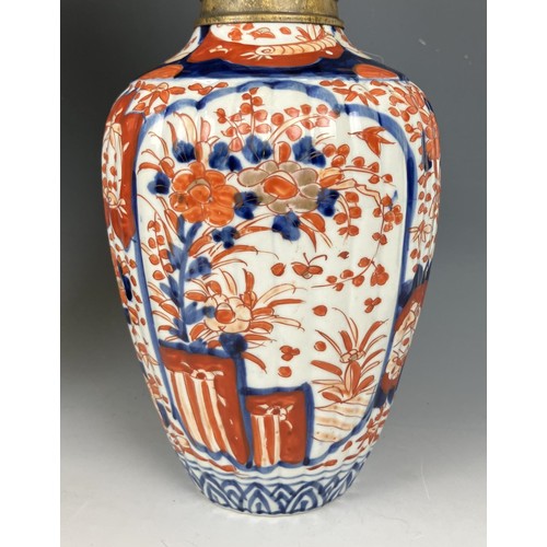 1800 - A Japanese Imari vase, converted to an oil lamp, with an acid etched glass shade, 46 cm high, and an... 