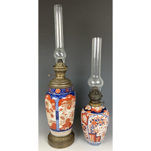 1800 - A Japanese Imari vase, converted to an oil lamp, with an acid etched glass shade, 46 cm high, and an... 