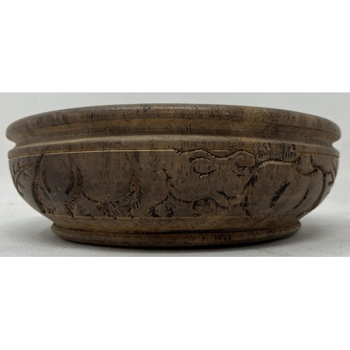 1824 - An African carved wooden bowl, 17 cm diameter, and a candle stand, probably from Makonde, 19 cm high... 