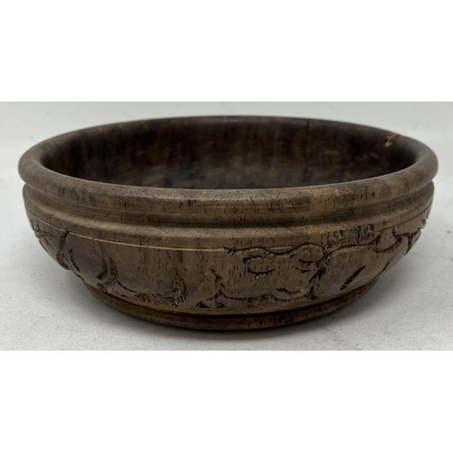 1824 - An African carved wooden bowl, 17 cm diameter, and a candle stand, probably from Makonde, 19 cm high... 