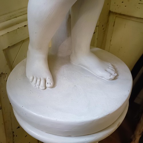 1903 - A plaster composition figure, of a young boy holding a bowl with outstretched arms, on a column base... 