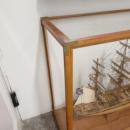 1886 - A model of the Cutty Sark, in a teak and perspex case, 140 cm wide