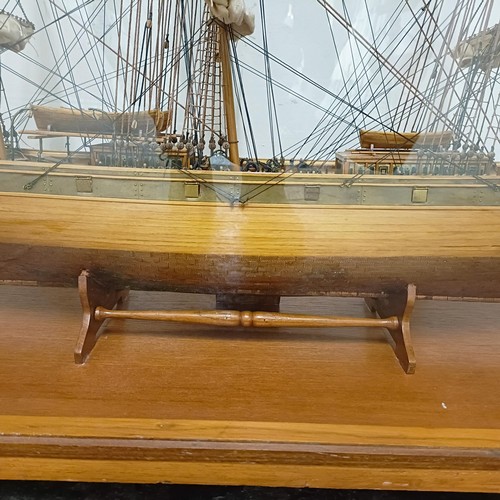 1886 - A model of the Cutty Sark, in a teak and perspex case, 140 cm wide