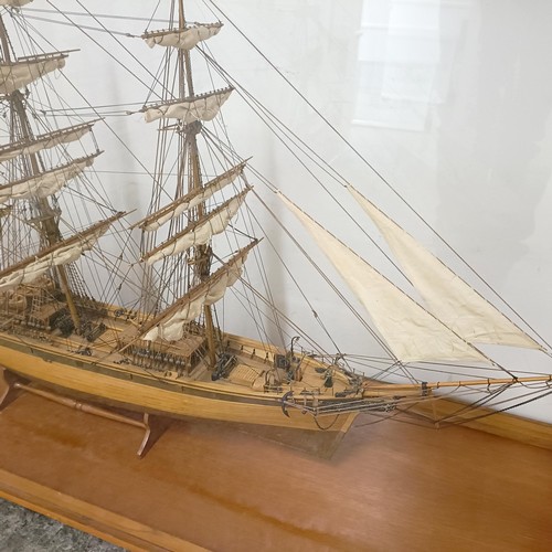 1886 - A model of the Cutty Sark, in a teak and perspex case, 140 cm wide