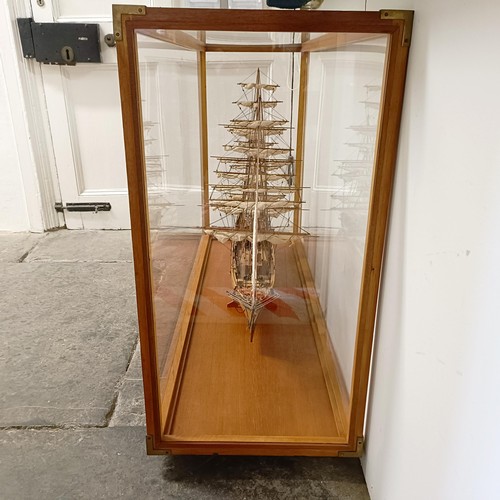 1886 - A model of the Cutty Sark, in a teak and perspex case, 140 cm wide