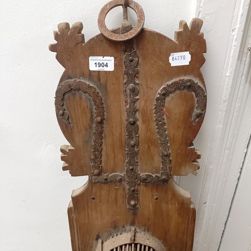 1904 - A wall mounted wooden plaque with metal spikes, 100 cm