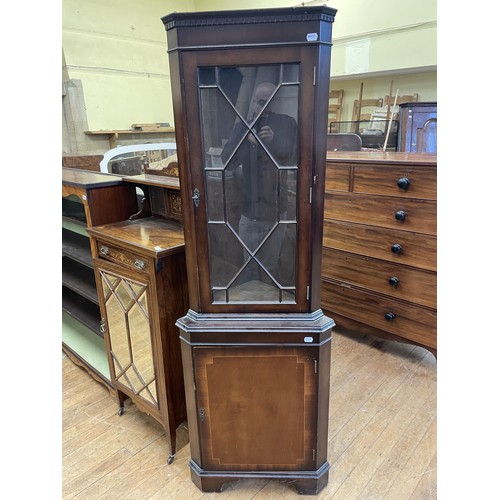 1975 - A brass bound teak trunk, with a later lock, 92 cm wide, a corner cabinet and a bedside chest with t... 