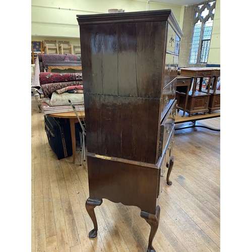 1962 - A walnut tallboy, the top having two short and three long drawers, the base with three drawers, on c... 