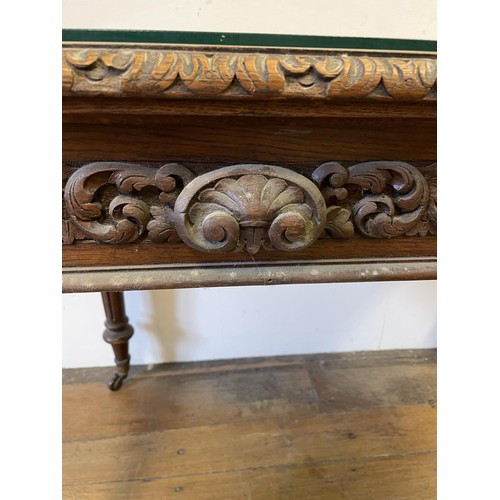 1963 - An oak writing desk, with a tooled and gilt leather top, having two drawers, on carved turned and re... 