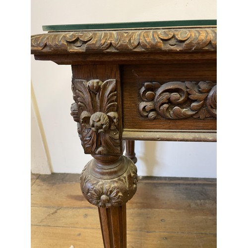 1963 - An oak writing desk, with a tooled and gilt leather top, having two drawers, on carved turned and re... 