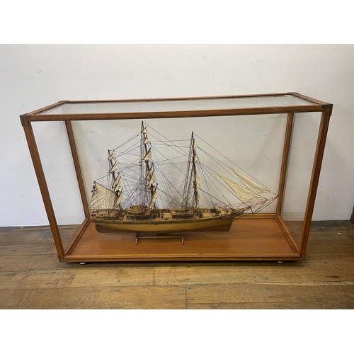 1886 - A model of the Cutty Sark, in a teak and perspex case, 140 cm wide