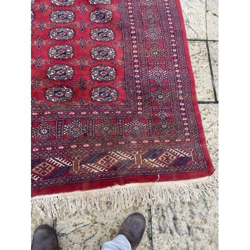 1985 - An Afghan red ground carpet, 380 x 270 cm