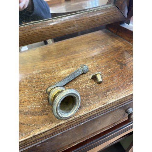 1973 - An oak bedroom mirror, with a single drawer to the base, 40 cm wide