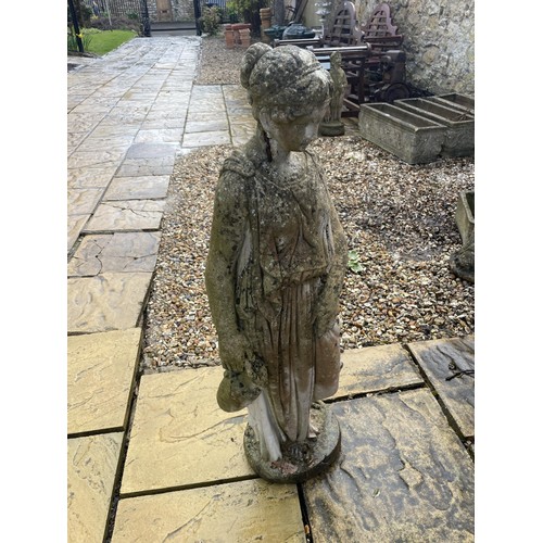 2025 - A composite stone garden figure of a lady, 100 cm high