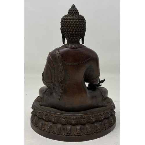 942 - A Chinese bronze Buddha, 15 cm high