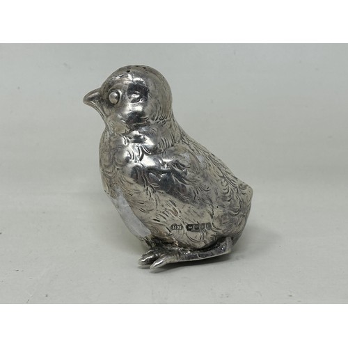 5 - A novelty Continental silver coloured metal pepper, in the form of a chick, import marks for London ... 