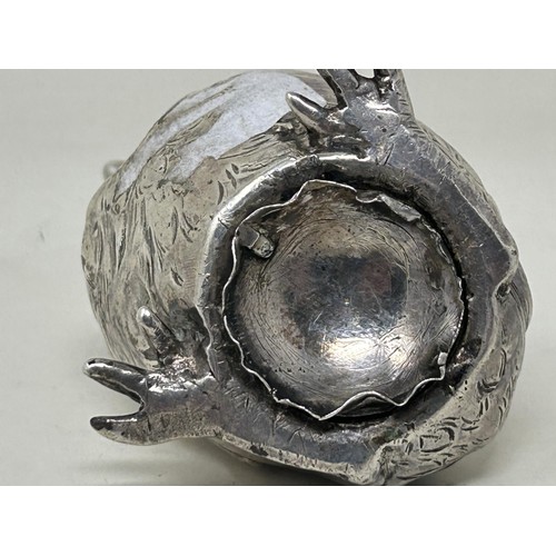 5 - A novelty Continental silver coloured metal pepper, in the form of a chick, import marks for London ... 