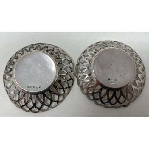 7 - An Indian silver coloured metal sugar bowl, assorted teaspoons, a napkin ring, a pair of pierced dis... 