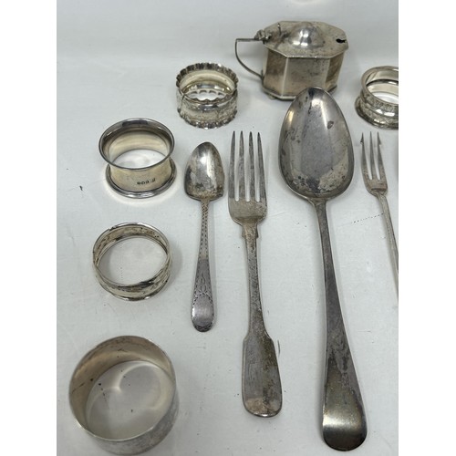 8 - A silver Old English pattern spoon, assorted napkin rings, a mustard pot, and flatware, various date... 