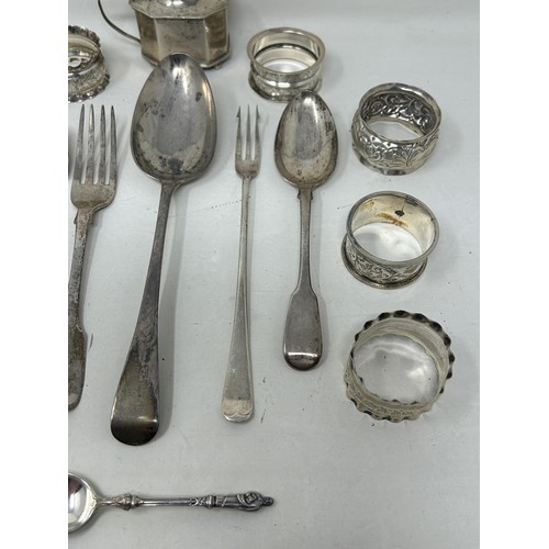 8 - A silver Old English pattern spoon, assorted napkin rings, a mustard pot, and flatware, various date... 