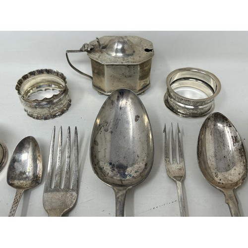 8 - A silver Old English pattern spoon, assorted napkin rings, a mustard pot, and flatware, various date... 