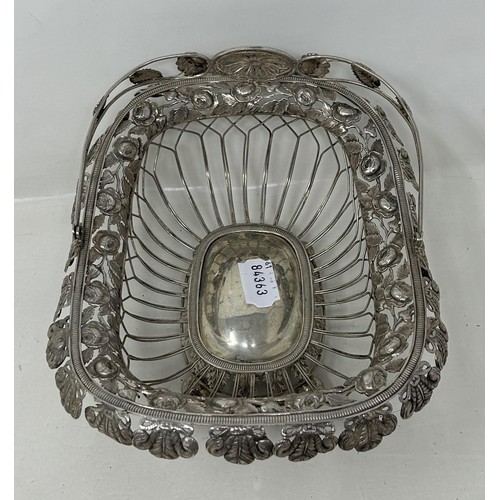 25 - A silver coloured metal pierced swing handled basket