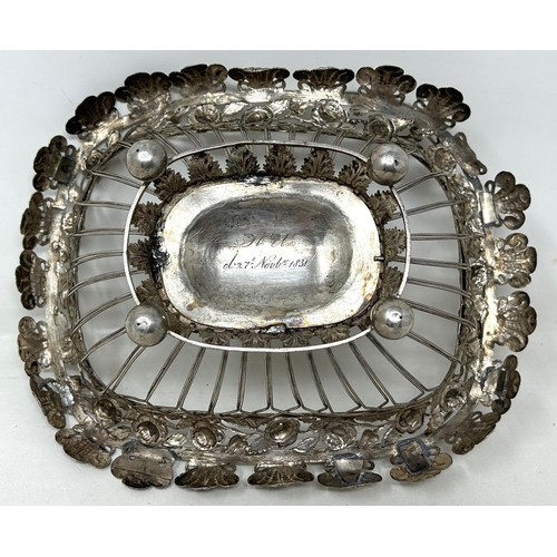 25 - A silver coloured metal pierced swing handled basket