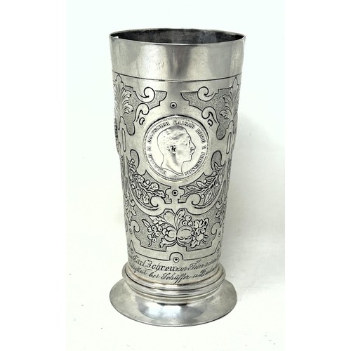 32 - A Continental silver coloured metal beaker, inset with coins, .800