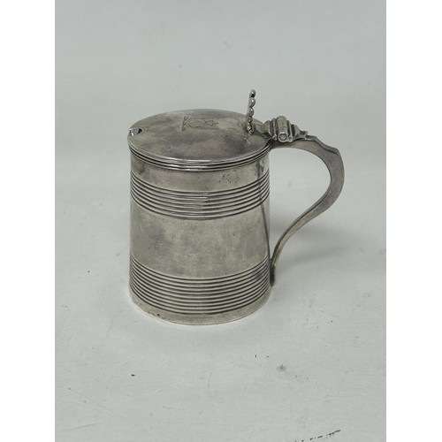 49 - A George III silver mustard, in the form of a tankard, London 1807, 2.3 ozt, and an associated spoon... 