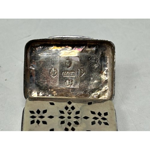 50 - A 19th century silver vinaigrette, marks rubbed, another, and a silver and enamel vinaigrette (3)