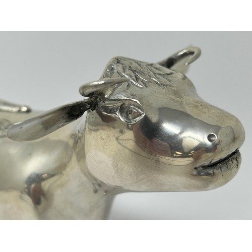 89 - A Continental silver coloured metal novelty creamer, in the form of a cow