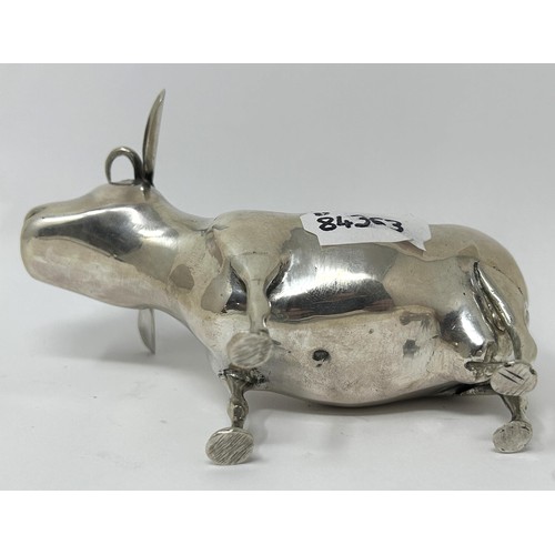 89 - A Continental silver coloured metal novelty creamer, in the form of a cow