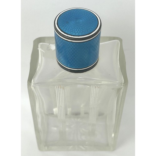 94 - A silver, blue and white enamel topped glass perfume bottle, 12 cm high