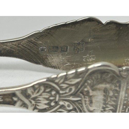 108 - A pair of Edward VII sugar tongs, 1908, another pair, 1943, and a silver coloured metal pair (3)