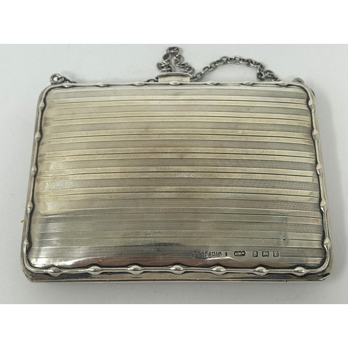 111 - A George V silver purse, with a leather interior, Birmingham 1914, 4.2 ozt all in