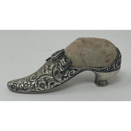 115 - A novelty silver coloured metal pin cushion, in the form of a shoe