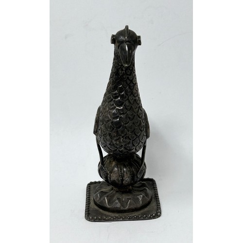 138 - A Persian silver coloured metal mount, in the form of a bird, 10 cm high