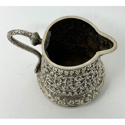 180 - An Indian silver coloured metal cream jug, 3.58 ozt