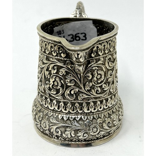 180 - An Indian silver coloured metal cream jug, 3.58 ozt