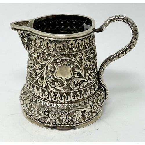 180 - An Indian silver coloured metal cream jug, 3.58 ozt