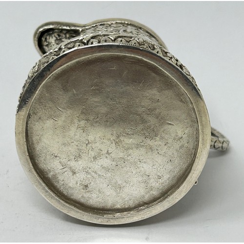 180 - An Indian silver coloured metal cream jug, 3.58 ozt