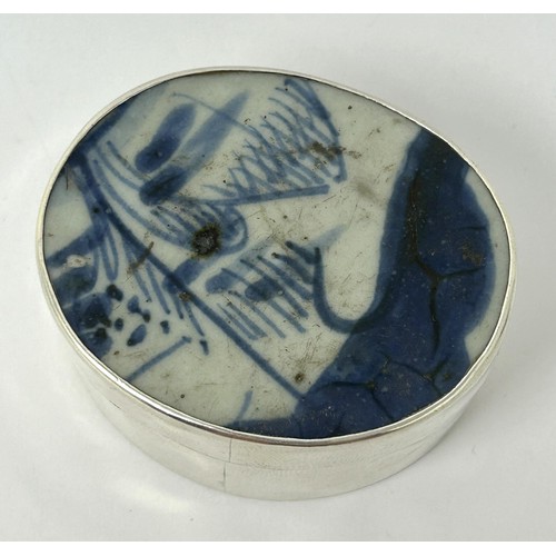 185 - A Continental silver coloured metal oval box, top inset with blue and white ceramic panel