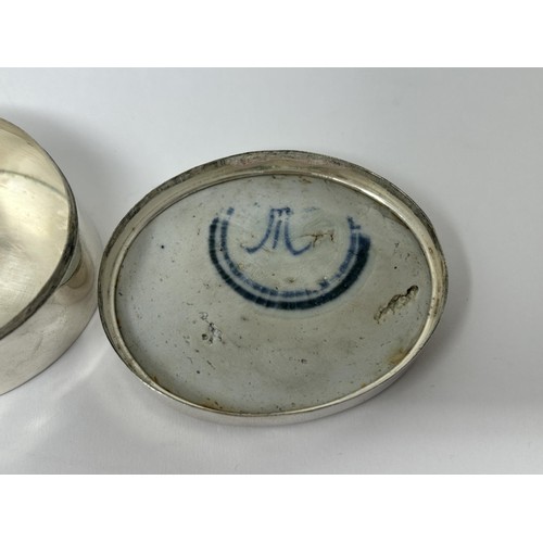 185 - A Continental silver coloured metal oval box, top inset with blue and white ceramic panel