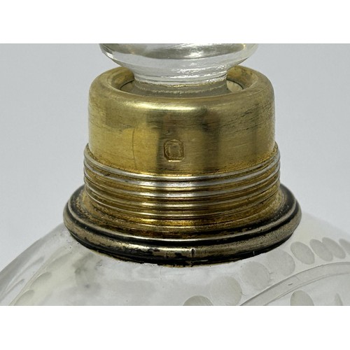 190 - An engraved glass perfume bottle, with gilt metal cap, 12 cm high