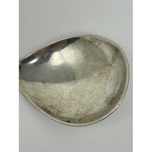 195 - A silver coloured metal caddy spoon, 4 g