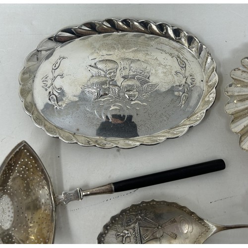 218 - A shell shaped dish, Birmingham 1903, a caddy spoon, a sifter spoon, and an oval tray, various dates... 