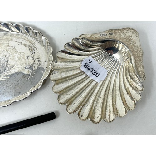 218 - A shell shaped dish, Birmingham 1903, a caddy spoon, a sifter spoon, and an oval tray, various dates... 